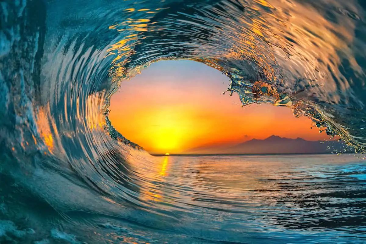 Colorful vibrant Sunset Sea water ocean wave in barrel shape for surfing